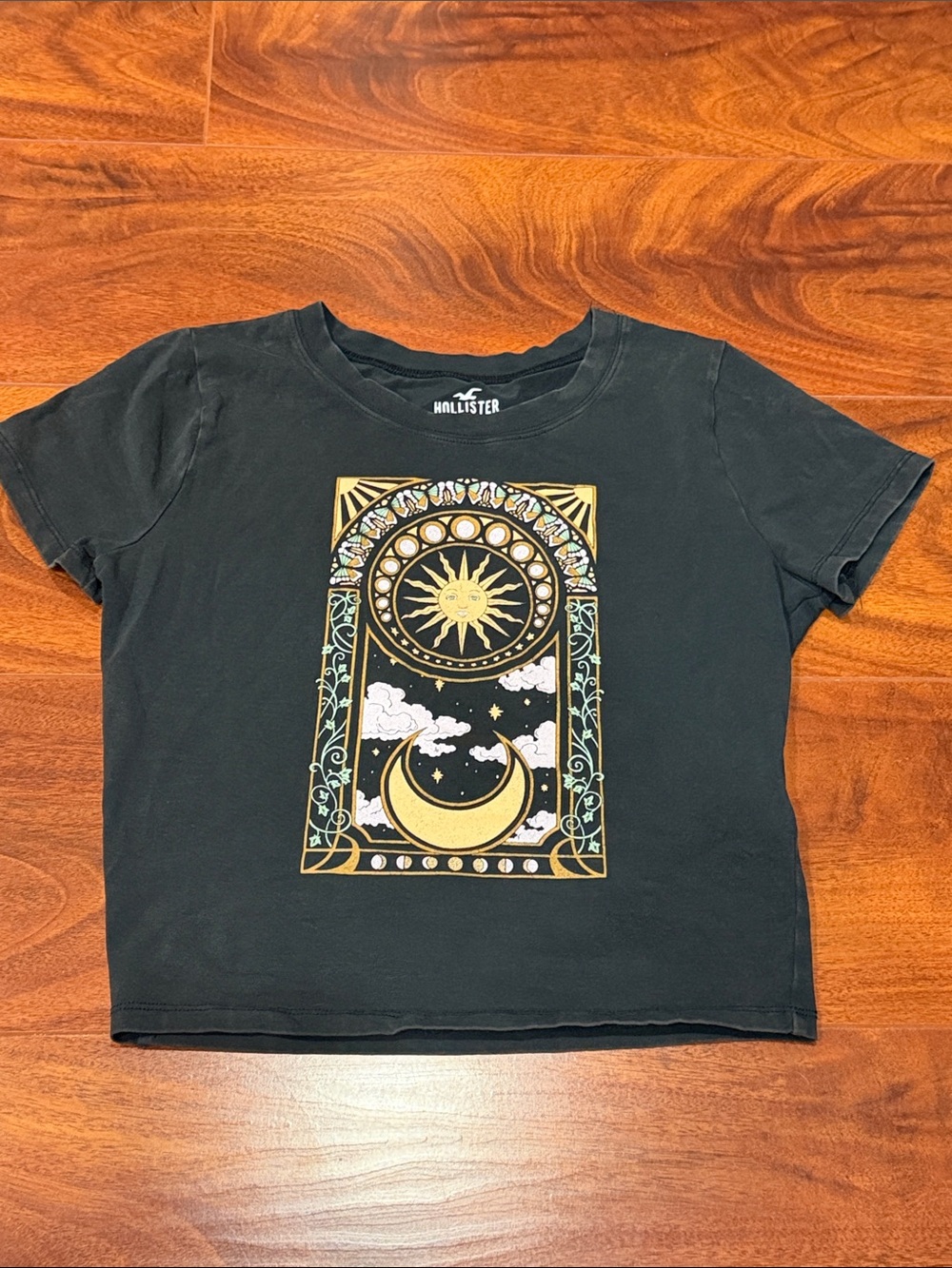 Hollister Black Baby Tee with Gold Sun & Moon Graphic